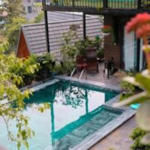 a swimming pool in front of a house at Roses Homestay- Venuestay in Tam Ðảo