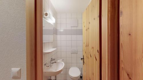 a bathroom with a white toilet and a sink at Pracondu 2 207 - OUTDOOR & FUN apartment 4 pers in Nendaz