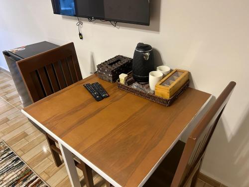 a wooden dining table with chairs and a television at Stayline hotel apartments 5 mins from Cairo airport in Cairo