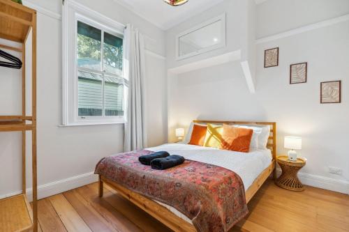 a bedroom with a bed and a window at The Greenhouse - Cozy Blue Mountains Retreat in Blackheath