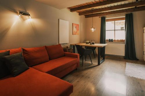a living room with a couch and a table at Apartments Moarhof in Feldthurns