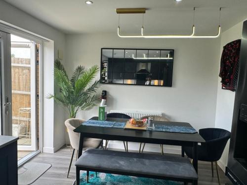 a dining room with a table and chairs and a window at Middle Kent Lux! in Moffat