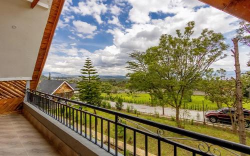 a balcony with a view of a road and trees at The Cabin Azure in Naivasha