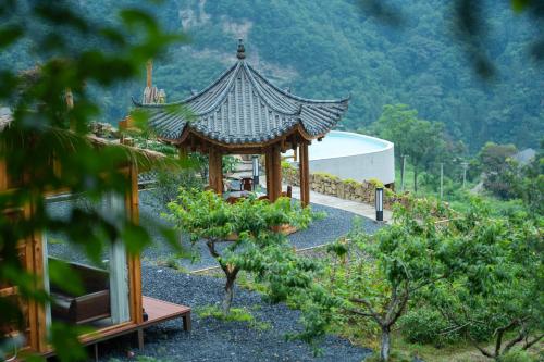 a gazebo in the middle of a garden at Celestial Valley in Zhangjiajie
