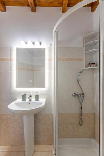a bathroom with a sink and a shower at Caruana Living in Agia Anna Naxos