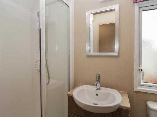 a bathroom with a sink and a shower at Aspen in Denny