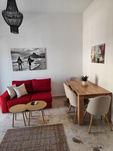 a living room with a red couch and a table at Grimihome 2 in Filiatra