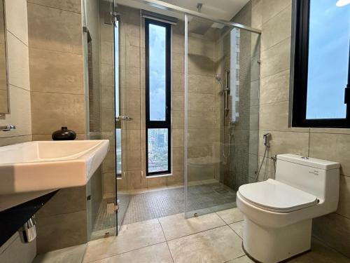 a bathroom with a toilet and a sink and a shower at KL Central 33rd Floor KLCC view in Kuala Lumpur