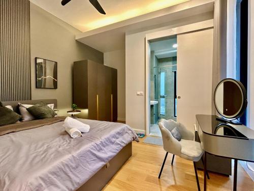 a bedroom with a bed and a desk and a mirror at KL Central 33rd Floor KLCC view in Kuala Lumpur