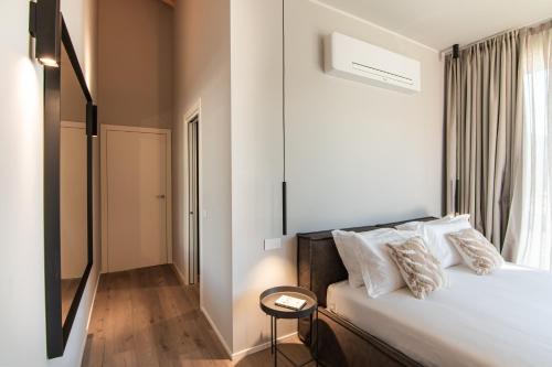 a bedroom with a bed with a chair and a window at Villa Sabrina in Colico