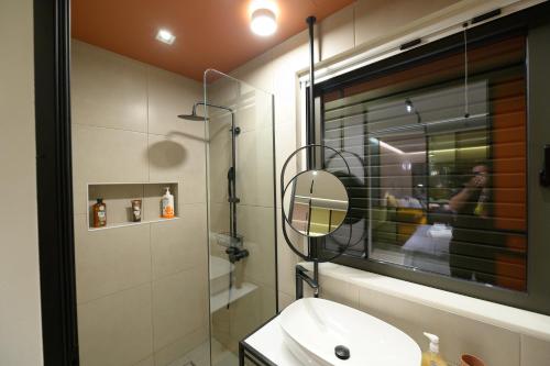 a bathroom with a sink and a mirror at Antinea Olympian Villa in Olympia