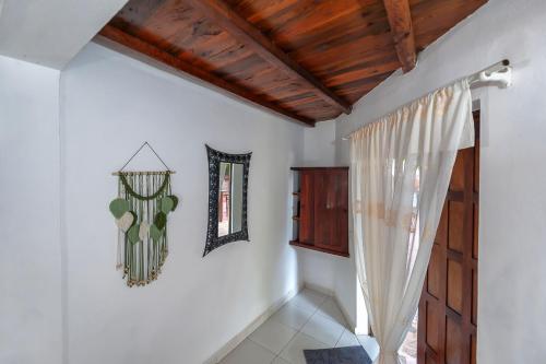 a room with white walls and a wooden ceiling at A casa di Giorgia lodge Nosy be Andilana in Nosy Be