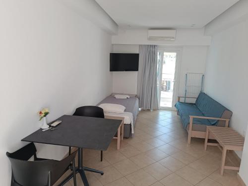 a living room with a couch and a table at Georgia Hotel Apartments in Protaras