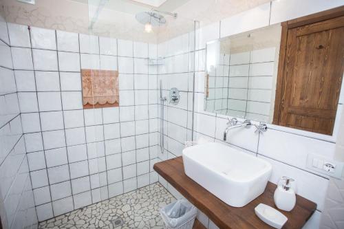 a white bathroom with a sink and a mirror at Locanda Antico Casale Cesenatico in Cesenatico
