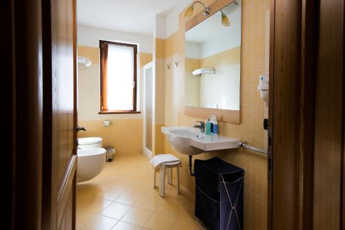 a bathroom with a sink and a toilet at Residence Corte Camaldoli in Garda