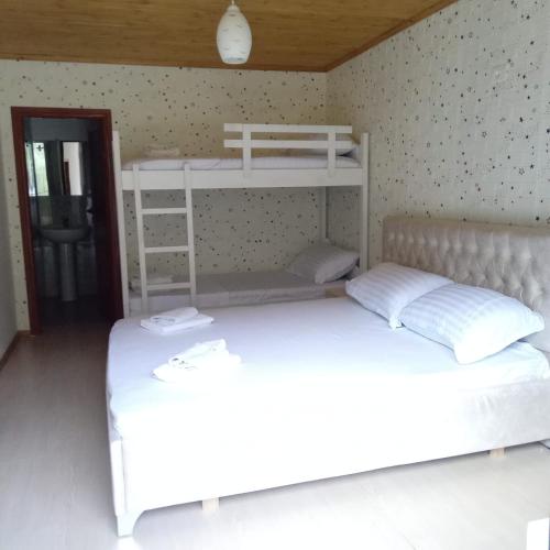 two beds in a room with two bunk beds at Vila Axhemi by Kei in Vlorë