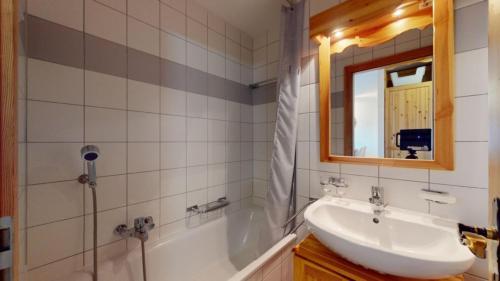 a bathroom with a sink and a tub and a mirror at Pracondu 2 302 - OUTDOOR & FUN apartment 4 pers in Nendaz