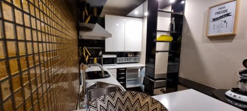 a kitchen with a sink and a counter top at Käuzchenquartier Design Ferienwohnung mit traumhaftem Fernblick in Bad Oeynhausen