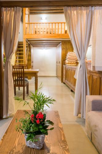 a living room with a table with flowers on it at To Kamariko in Soroni
