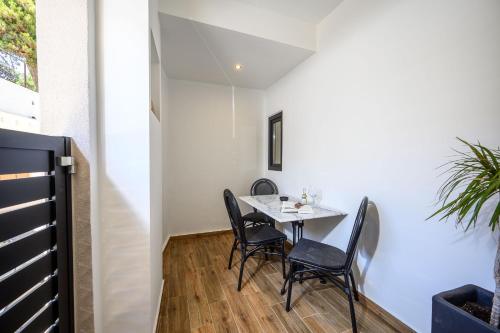 a small dining room with a table and chairs at Montre Fine Living in Agios Nikolaos