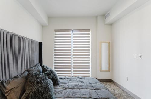 a bedroom with a bed and a large window at Modern 2BR, Family-Friendly in FLL, Near Beach! in Fort Lauderdale