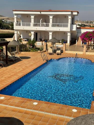 a large swimming pool in front of a building at Apartamentos Turísticos Los LLanos in Cuevas del Almanzora