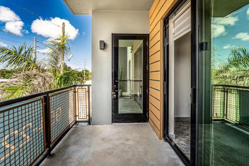 an open door to the balcony of a house at Modern 2BR, Family-Friendly in FLL, Near Beach! in Fort Lauderdale