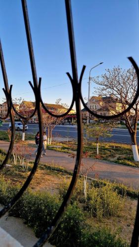 a view of a street through a metal fence at Морской бриз in Aktau