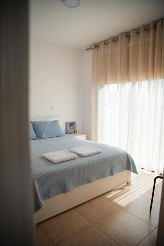 a bedroom with a bed and a window at Villa Lela in Paralimni