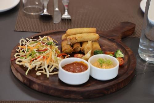 a plate of food on a wooden tray with food at Pallacia A Luxury Hotel in Beāwar