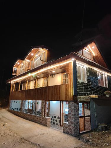a building with lights on top of it at night at Deodar Homestay Dakbangla-kufri in Shimla