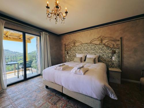 a bedroom with a large bed and a chandelier at Domaine Santa Margherita in Castellare-di-Casinca