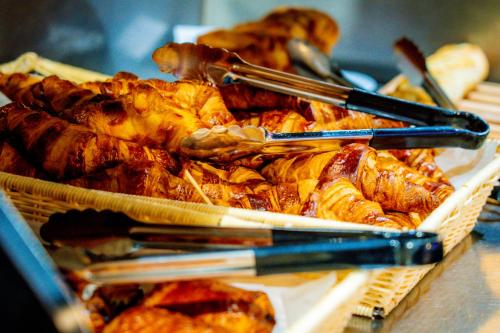 a bunch of different types of food with chop sticks at Campanile Grenoble Nord - Moirans-Voreppe in Moirans