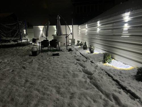 a yard covered in snow at night with a fence at Casa Tofalvi in Sovata