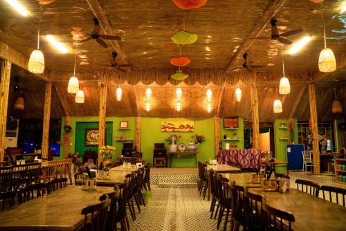 a dining room with tables and chairs and lights at Minh Chau Beach Resort in Quang Ninh