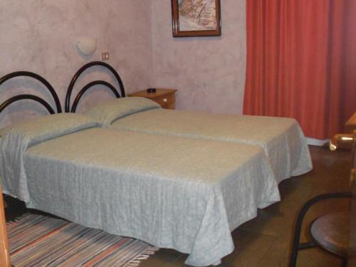 a bedroom with a bed and a red curtain at Marta in Trieste