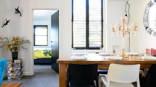 a dining room with a wooden table and white chairs at LACROIX - DAYLESFORD in Daylesford