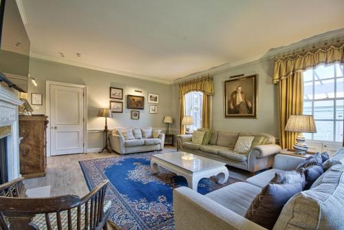 a living room with a couch and a table at Abbey House by Group Retreats in Saffron Walden