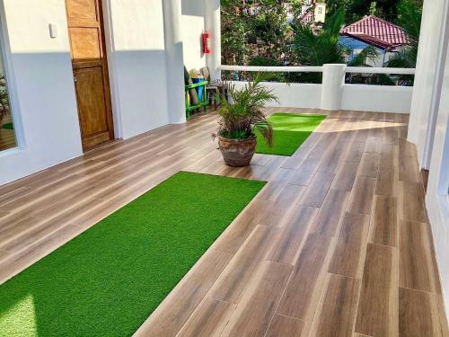 a living room with green mats on the floor at Couple room C in Final Destination Resort in Bolinao
