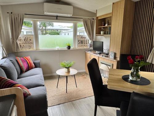 a living room with a couch and a table at KD 814 - Vakantiepark Kijkduin in Kraaijenstein