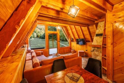 a living room with a couch and a table in a cabin at Woodland Brezna in Pluzine
