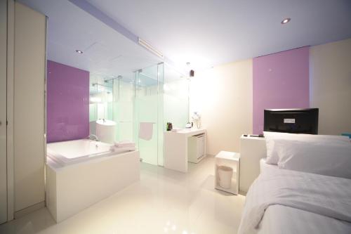 a white bathroom with a bed and a sink at Jongno Hotel Pop Leeds Premier in Seoul