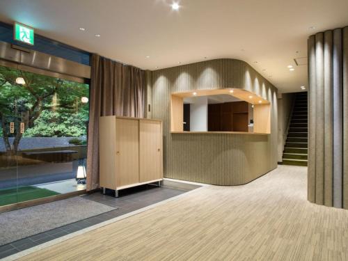 an empty room with a staircase and a room with a stair case at Takao Kanko Hotel in Kyoto
