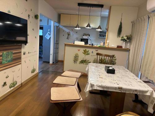 a living room with a table and chairs and a kitchen at I LOVE HAKONE in Hakone