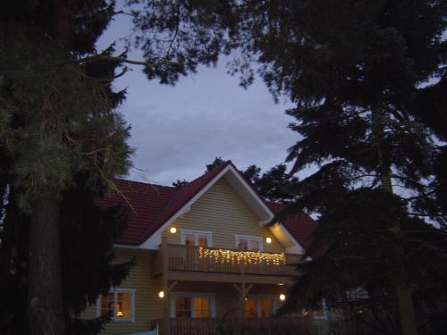a house with a balcony with lights on it at Haus Stoertebeker Appartements - Hotel Garni, Seebad Lubmin in Lubmin