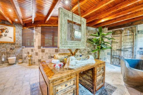 a bathroom with a tub and a wooden ceiling at Cortijo Boutique Marbella in Marbella