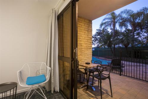 a patio with chairs and a table on a balcony at Nightcap at Kawana Waters Hotel in Kawana Waters