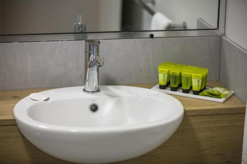 a white sink in a bathroom with a mirror at Nightcap at Kawana Waters Hotel in Kawana Waters