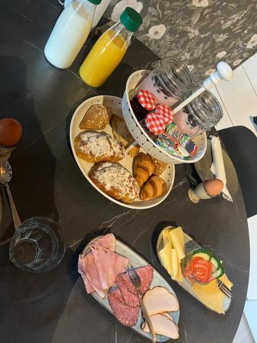 ein Tisch mit drei Tellern mit verschiedenen Arten von Essen in der Unterkunft B&B op de Heuvelrug in Leersum