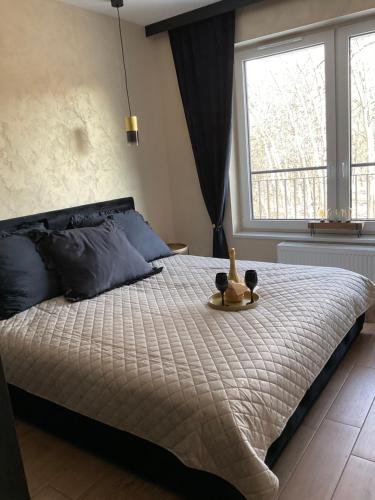a bedroom with a bed with a toy on it at Apartament Zielona Dzielnica in Gliwice